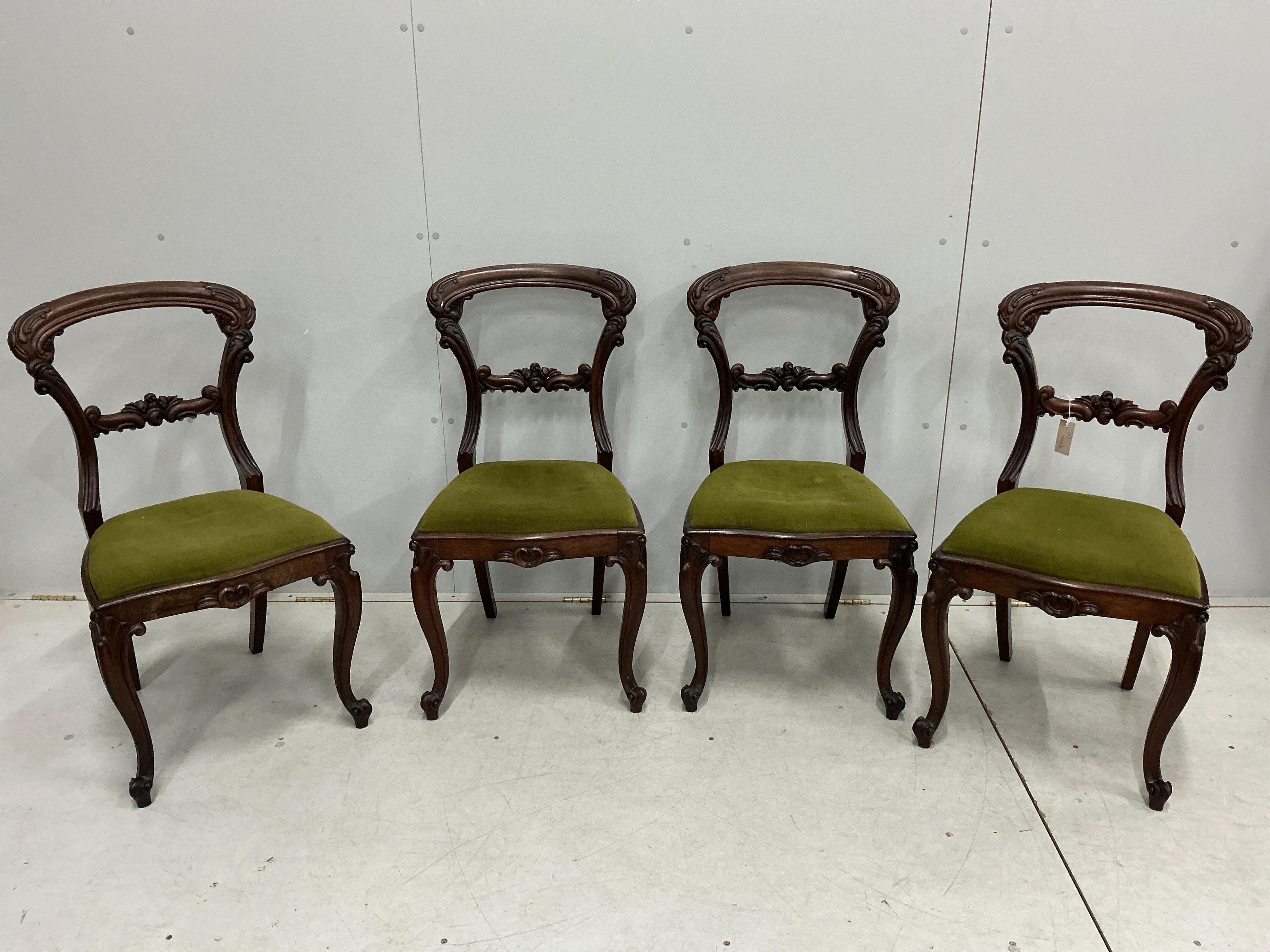 A set of four early Victorian rosewood balloon back dining chairs, height 86cm